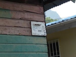 Picture of opening times sign on the building. Shows that it opens Tues and Thurs-Sun at 12 noon. at Jah Lamb's in Soufriere