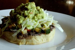 Vegan sope: corn masa fried with black mashed beans, then grilled veggies, letuce & guacamole. at Adelitas Taqueria in San Jose