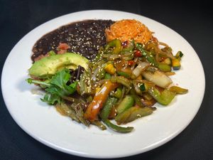 Vegan FAJITAS with nopales (cactus) sauteed onions, bell peppers, tomatoes, serrano & seasonal veggies, served with black beans & Mexican rice. Corn or flour tortillas. at Adelitas Taqueria in San Jose