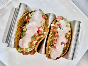 Tasty Tacos: We make our tacos out of butternut squash  and crack open a young coconut to make the sour cream.  at Conscious Kitchen Atx in West Lake Hills