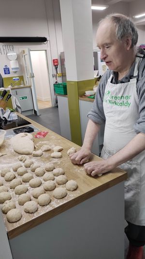 Volunteer baker making bread rolls to go with soup. at Greener Kirkcaldy - Community Meal  in Kirkcaldy