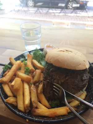 Hot and spicy burger with fries and salad.  at Just Vege in Helsinki