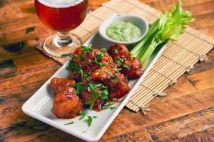 French Meadow "Earth Wings" (R) - (Vegan & Gluten-Free) Flash-fried cauliflower in house-made BBQ sauce, fresh celery, house-made soy-cilantro dipping sauce at French Meadow Bakery & Cafe in Minneapolis