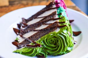 Rose Cake (vegan & gluten-free) - Rich chocolate cake layers with naturally-died vanilla frosting at French Meadow Bakery & Cafe in Minneapolis