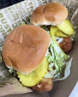 Dish at the MN State Fair 2022: Earth Sliders (vegan fried chicken patty, mildly spicy secret sauce, lettuce, house made cucumber pickles, grilled bun)  at French Meadow Bakery & Cafe in Minneapolis