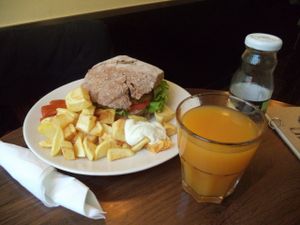 Burger on the plate with potatoes  at Entre Pedras in Santiago De Compostela