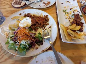 Prato case rematado de zorza (non deu tempo a sacar foto) e prato de seitán con ensalada e patacas. at Entre Pedras in Santiago De Compostela