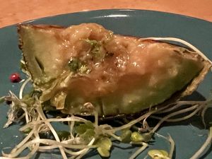 Grilled avocado sliced to show color and sauce   at Organic Plus in Sapporo