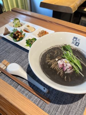 Jet black ramen made with black sesame soup and noodles kneaded with black pepper. at Ayasai - 采菜 in Kyoto