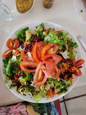 Salad with tomatoes added. at Como En Mi Casa in Puerto Viejo De Talamanca