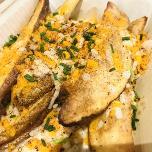 Golden Potato Wedges w/ vegan cheese & chives  at Fresh Potato Factory in Northridge