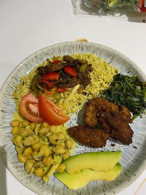 Ital Sunshine coco-curry chickpeas, grilled oyster mushrooms and peppers served on yellow basmati rice, steamed callaloo, fresh avocado and falafel at Empress Ima's Ital Café & Nyce Creamery in Philipsburg