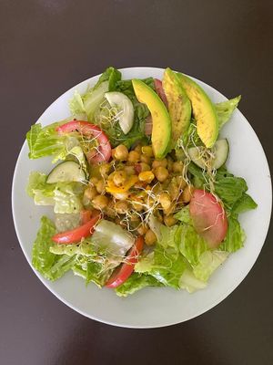 Sunshine salad with marinated chickpeas served with red, gold and green: fresh tomatoes, avocados and local cucumbers at Empress Ima's Ital Café & Nyce Creamery in Philipsburg