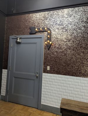 Sign references you to go downstairs at Soul Garden Bath and Body in Reno