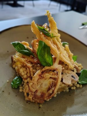 Venkelbeignet ° parelcouscous ° gele tomaat ° basilicum °voorjaardpaddenstoelen. at Katz in Ruurlo