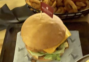 Vegan burger comes with a side of fries.   at Seven Sports Bar - NH Collection  in Dubai