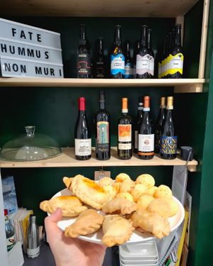 Selection of vegan empanadas and vegetarian pao de queijo at Gastronomia - L'agenzia di Viaggi in Turin