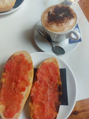 Bread with oil and tomato and soy milk cappuccino at Isolina  in Malaga