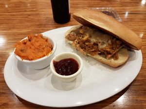 Seasonal Turkey Dinner Sandwich with the cranberry sauce on the side and mashed yams at Veggie Grill by Next Level in Carlsbad
