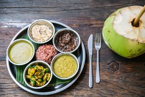 Thali with Indian delicious dishes, chutneys, papadam at Samadi Kitchen Lab in Canggu
