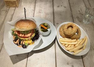 Cheeseburger comes with pickles and fries. I added onion rings to my order!  at AIN SOPH.Soar in Tokyo