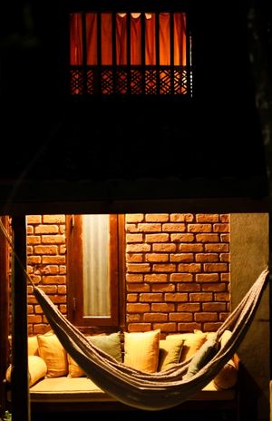 Outdoor Hammock and sofa facing the lush forest at Moss Forest Vegan  in Hadigalla