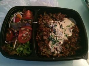 red rice with lentils and tahini sauce, side salad at Shiloh Vegetarian Cafe in Berlin