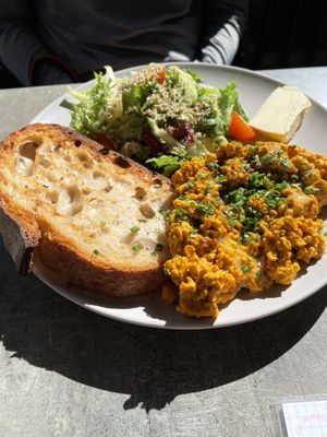 Tofu scramble with slice of bread, butter, and salad  at Stullenfabrik in Leipzig