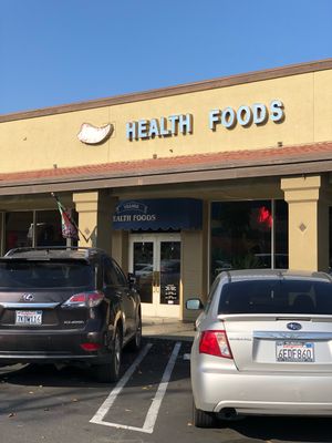 Store front. Grocery/supplement/herbal store with small juice/sandwich bar inside at Village Health Foods in Modesto
