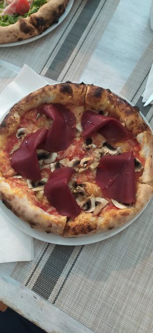 Pizza regina at Swami's Garden in Praia Da Luz