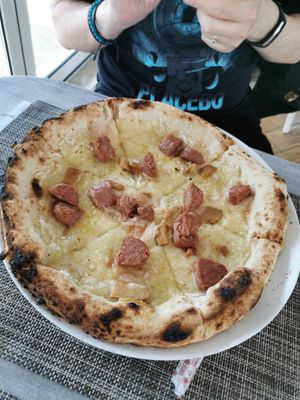 Vegan cheese and sausage pizza at Swami's Garden in Praia Da Luz