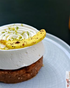 

Crunchy Breton shortbread base with chocolate, salted caramel, banana flambéed with rum, Madame coconut cream at Les Artizans - Coffee And Flower in Paris
