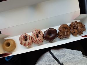 Apple fritters on the right  at Cartems Donuts - Downtown in Vancouver