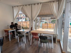 Several two seater tables are available for chatting or working on your laptop. at Gleam & Sip  in Toronto