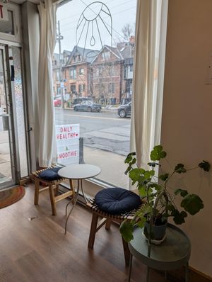 Side table with two stools. at Gleam & Sip  in Toronto