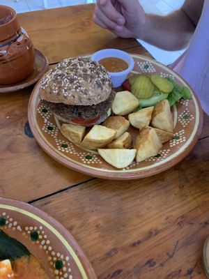 Vegan burger, pickles on the side  at Vegetariano Mar y Tierra in Tulum