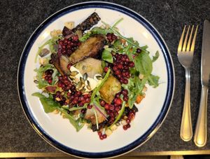 Potato dumplings, lingon berries, tempeh, root vegetables, rocket at ÖUR in Stockholm