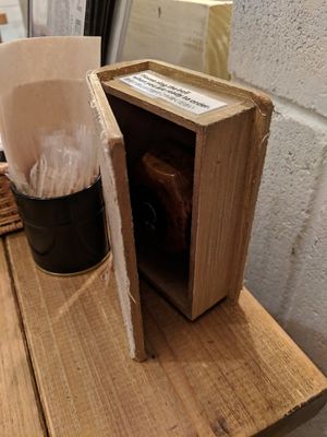 Push the button inside the book/box to call the server.  at Paprika Shokudo Vegan in Osaka
