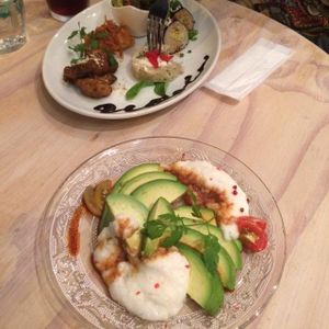 assorted appetizer sampler and sliced avocado with tororo and soy sauce at Paprika Shokudo Vegan in Osaka