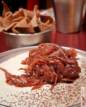 Creamy dip, spicy onion, and tortilla chips
Buckwheat tortilla, white beans, spicy onion confit at Maslow - Temple in Paris