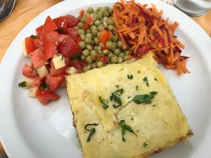 Potato-seitan casserole with cold salads. at Uriel in Cordoba