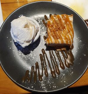 Lotus Biscoff cheesecake served with butterscotch sauce and vegan ice cream at Plough and Flail in Knutsford