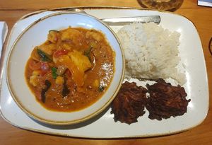 Cauliflower, red pepper & spinach Keralan curry served with steamed basmati rice and onion bhajis at Plough and Flail in Knutsford