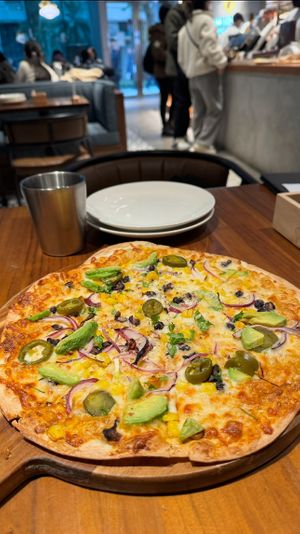 Pizza with avocado, jalapeños, corn, onions and black olives  at Preserve in Taipei