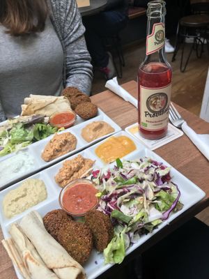 Falafel plate (3 falafel balls, pita bread, salada, 3 dips of your choice and chili tomato sauce on request) at Vegi in Tubingen