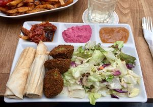 Falafel plate with red beet hummus, mango chutney and eggplant dip. at Vegi in Tubingen