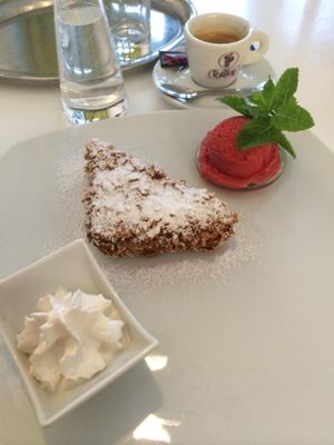 Dessert :D A vegan Berliner with soy whip, homemade strawberry cashew milk ice cream, and a shot of espresso to top it off  at The Green Garden in Salzburg