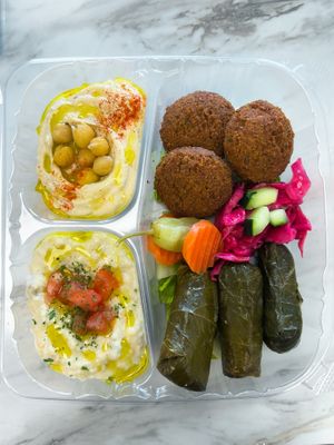 Mix appetizers( humus, eggplant dip( babaganouge ,grape leaves) at Zakee Mediterranean Street Food in Akron