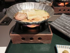 The third course: onabe (vegetables, yuba, and mochi that you cook in broth over a flame). This is after I had put the vegetables in the broth. at The Dining - Shiba Park Hotel in Tokyo