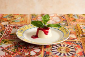 Homemade vegan panna cotta. Made with soy cream and oat milk, topped with raspberry coulis. at La Posata in Frederiksberg